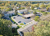 Thumbnail 25 of 26 - A parking lot is surrounded by a grassy area and a few trees.