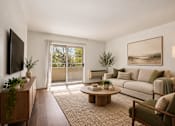 Thumbnail 9 of 35 - A living room with a couch, chair, and a television.