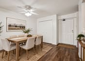 Thumbnail 35 of 35 - A dining room with a wooden table and chairs.