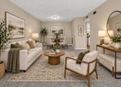Thumbnail 6 of 27 - Virtually staged living room with a white sofa, wooden coffee table, and round wall mirror at Arbours at Victoria Place in Prattville, AL
