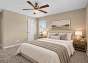 Thumbnail 10 of 27 - Virtually staged bedroom with a large bed and ceiling fan at Arbours at Victoria Place in Prattville, AL