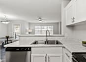 Thumbnail 1 of 39 - A modern kitchen with a marble countertop and stainless steel appliances.