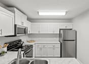 Thumbnail 2 of 39 - A kitchen with white cabinets and appliances.