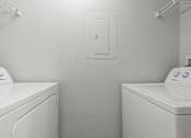 Thumbnail 9 of 39 - Two front load washing machines in a laundry room.