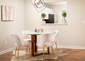 Thumbnail 4 of 22 - Dining room with white table and chairs at Southwind Apartments in Richland, MS.