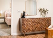 Thumbnail 9 of 22 - Room with a chair, table, and mirror at Southwind Apartments in Richland, MS.