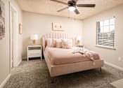 Thumbnail 6 of 22 - Bedroom featuring a pink bed and ceiling fan at Southwind Apartments in Richland, MS.