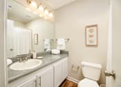 Thumbnail 8 of 22 - Bathroom with white toilet and sink at Southwind Apartments in Richland, MS.