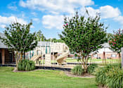 Thumbnail 14 of 22 - Community playground with slide at Southwind Apartments in Richland, MS.