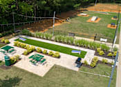 Thumbnail 12 of 38 - A park with a green lawn and a baseball field.