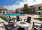 Thumbnail 7 of 38 - Poolside seating area at The Foundry Carrollton GA
