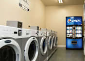 Thumbnail 4 of 37 - A row of washing machines in a laundromat.