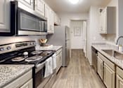 Thumbnail 3 of 24 - a kitchen with a stove top oven next to a sink