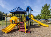 Thumbnail 5 of 24 - a playground with a yellow and blue slide and monkey bars
