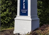 Thumbnail 18 of 24 - a column with a blue sign on top of it