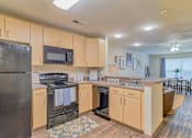 Thumbnail 8 of 38 - Kitchen with wood cabinets at The Foundry Carrollton GA
