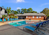 Thumbnail 21 of 25 - Resort-Style Pool with Seating at Lakeland East Apartments – Flowood, MS