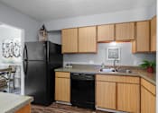 Thumbnail 6 of 25 - Well-Appointed Kitchen with Black Refrigerator at Lakeland East Apartments – Flowood, MS