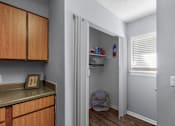 Thumbnail 9 of 25 - Kitchen with Pantry Access at Lakeland East Apartments – Flowood, MS