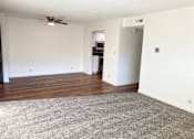 Thumbnail 5 of 16 - A room with a ceiling fan and a carpeted floor.