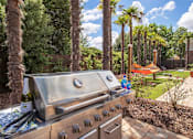 Thumbnail 16 of 19 - a barbecue grill in a backyard with palm trees