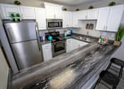 Thumbnail 7 of 19 - a kitchen with stainless steel appliances and a counter top