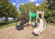 Thumbnail 18 of 20 - a playground with a slide at a park