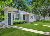 Thumbnail 23 of 26 - a row of white houses with blue and yellow doors and a lawn