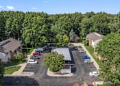 Thumbnail 30 of 30 - an aerial view of a neighborhood with cars parked in a parking lot