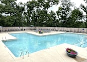 Thumbnail 25 of 34 - a swimming pool with chairs around it