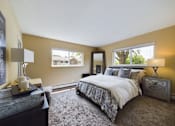Thumbnail 1 of 22 - A bedroom with a large bed and a window.