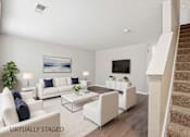 Thumbnail 5 of 25 - A living room with a staircase on the right side.