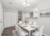 Thumbnail 7 of 25 - A dining room with a white table and chairs.