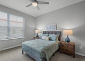 Thumbnail 11 of 19 - a bedroom with a bed and a ceiling fan
