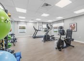 Thumbnail 18 of 19 - Salem Village Fitness Room with treadmill and exercise bike