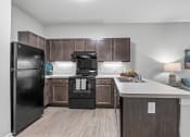 Thumbnail 6 of 19 - a kitchen with black appliances and wooden cabinets