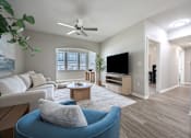 Thumbnail 3 of 26 - Living room with ceiling fan at Sunday Village Apartments, Austin, Texas