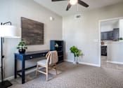 Thumbnail 9 of 26 - an open living room with a desk and a ceiling fan at Sunday Village, Texas