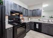 Thumbnail 6 of 26 - Kitchen at Sunday Village Apartments, Austin, TX