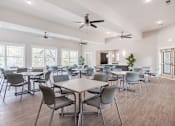 Thumbnail 24 of 26 - a dining room with tables and chairs and ceiling fans at Sunday Village, Texas