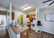 Thumbnail 11 of 35 - A modern kitchen with a wooden island and stainless steel appliances.