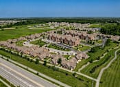 Thumbnail 35 of 35 - A suburban neighborhood with houses and a road.