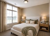 Thumbnail 13 of 35 - A bedroom with a large bed and a window with curtains.