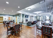 Thumbnail 24 of 35 - A large room with wooden floors and tables and chairs.
