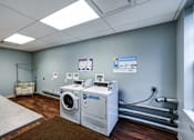 Thumbnail 29 of 35 - A room with a washing machine and a dryer.