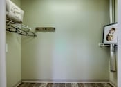 Thumbnail 12 of 35 - A laundry sign hangs on a wall next to a shelf and a picture frame.