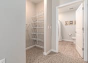 Thumbnail 5 of 20 - A white door is open to a bathroom.