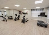Thumbnail 11 of 20 - A spacious gym with a variety of cardio equipment.