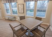 Thumbnail 12 of 20 - A dining room with a table and chairs.
