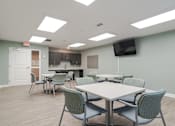 Thumbnail 8 of 16 - Craft room with tables, chairs, and TV at Sweetwater Point in Douglasville, GA